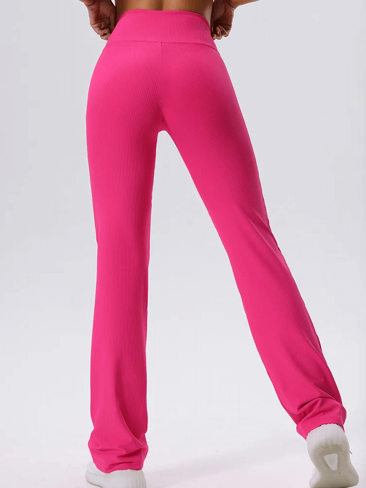 Vibrant pink ribbed yoga leggings with elastic waist, showcasing style and flexibility, perfect for yoga and active movement.